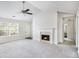 Living room with ceiling fan, fireplace, bright windows and neutral colored carpet at 332 Christian Ln, Carrollton, GA 30116