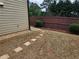 Well-maintained backyard featuring stepping stones, landscaping, and a wooden fence for privacy at 3943 Dunaire Dr, Stone Mountain, GA 30083