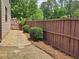 Well-maintained backyard featuring stepping stones, landscaping, and a wooden fence for privacy at 3943 Dunaire Dr, Stone Mountain, GA 30083