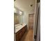 Bathroom featuring double sink vanity, large mirror, and tiled flooring at 3943 Dunaire Dr, Stone Mountain, GA 30083
