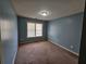 Cozy bedroom featuring plush carpeting, window, and soft blue walls at 3943 Dunaire Dr, Stone Mountain, GA 30083