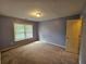 Bedroom with ample natural light, neutral carpeting, and access to closet at 3943 Dunaire Dr, Stone Mountain, GA 30083