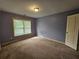 Bedroom with ample natural light, neutral carpeting, and access to closet at 3943 Dunaire Dr, Stone Mountain, GA 30083