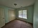Carpeted bedroom with double closet and window at 3943 Dunaire Dr, Stone Mountain, GA 30083