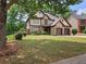 Charming home with a well-manicured lawn and a two-car garage, complemented by lush landscaping at 3943 Dunaire Dr, Stone Mountain, GA 30083