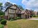 Beautiful two-story home boasts a two-car garage and manicured lawn with mature landscaping at 3943 Dunaire Dr, Stone Mountain, GA 30083