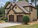 A two-car garage is attached to the home and it is surrounded by well-manicured greenery at 3943 Dunaire Dr, Stone Mountain, GA 30083