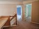 Upstairs landing features wood railing, carpeted floors and hallway at 3943 Dunaire Dr, Stone Mountain, GA 30083
