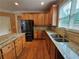 Traditional kitchen with wood cabinets, granite countertops, and stainless steel appliances at 3943 Dunaire Dr, Stone Mountain, GA 30083