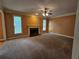 Large living room with fireplace, ceiling fan, and bright light from exterior windows at 3943 Dunaire Dr, Stone Mountain, GA 30083