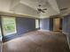 Large carpeted main bedroom with windows and overhead fan at 3943 Dunaire Dr, Stone Mountain, GA 30083