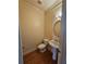 Well-lit powder room with pedestal sink, framed mirror, and hardwood floors at 3943 Dunaire Dr, Stone Mountain, GA 30083