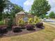 Beautiful community sign in a brick surround with colorful bushes at 3943 Dunaire Dr, Stone Mountain, GA 30083