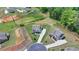 An aerial view of a two-story house with a well-maintained lawn and long driveway, in a suburban neighborhood at 3985 Foxdale Ln, Cumming, GA 30028