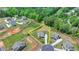 Aerial view of a property with its lot lines outlined, located in a quiet cul-de-sac near mature trees at 3985 Foxdale Ln, Cumming, GA 30028