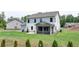 Spacious backyard with well-maintained lawn and screened in porch of a two story home surrounded by trees at 3985 Foxdale Ln, Cumming, GA 30028