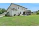 Expansive backyard with a screened porch, well-kept lawn, and a small patio area, perfect for outdoor enjoyment at 3985 Foxdale Ln, Cumming, GA 30028