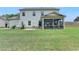Well-maintained backyard featuring a screened porch, lush green lawn, and a charming outdoor patio area at 3985 Foxdale Ln, Cumming, GA 30028