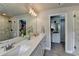 This bathroom features a double vanity, a glass enclosed shower, and a large mirror with Hollywood lights at 3985 Foxdale Ln, Cumming, GA 30028