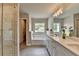 This bathroom features a double vanity, free standing soaking tub, and a large picture window for natural light at 3985 Foxdale Ln, Cumming, GA 30028