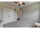 A view of a light gray bedroom with an open door and a closet with bi-fold doors at 3985 Foxdale Ln, Cumming, GA 30028
