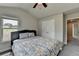 Bedroom with large windows, queen bed, and closet door to bathroom at 3985 Foxdale Ln, Cumming, GA 30028