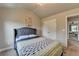 Bedroom features a bed with a blue headboard, a window, and large closet doors at 3985 Foxdale Ln, Cumming, GA 30028