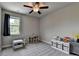 Bright bedroom with a ceiling fan, window, gray carpet, and storage at 3985 Foxdale Ln, Cumming, GA 30028