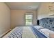 Bedroom featuring a bed with a blue headboard, a window, and carpet flooring at 3985 Foxdale Ln, Cumming, GA 30028