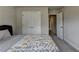 Bedroom with large closet doors, a window, and a floral quilt on the bed at 3985 Foxdale Ln, Cumming, GA 30028