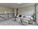 Bonus room with a couch, ottomans, and a decorative ceiling light fixture at 3985 Foxdale Ln, Cumming, GA 30028