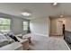 Bonus room with cozy seating, natural light from large windows, and access to upstairs landing at 3985 Foxdale Ln, Cumming, GA 30028