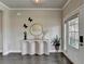 Elegant entryway featuring a modern console table, decorative butterfly accents, and a bright, welcoming atmosphere at 3985 Foxdale Ln, Cumming, GA 30028
