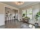 Inviting entryway with light walls, hardwood floors, a stylish console table, and a large window at 3985 Foxdale Ln, Cumming, GA 30028