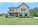 Charming two-story home boasts a beautifully landscaped front yard and welcoming curb appeal at 3985 Foxdale Ln, Cumming, GA 30028