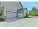 Three-car garage with a wide driveway, offering ample parking and storage space at 3985 Foxdale Ln, Cumming, GA 30028