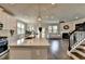 Modern kitchen open to the living room featuring white cabinets, hardwood floors, and stainless-steel appliances at 3985 Foxdale Ln, Cumming, GA 30028