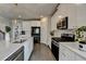 Bright, modern kitchen with white cabinets, stainless steel appliances, and a large island at 3985 Foxdale Ln, Cumming, GA 30028
