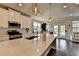 Bright, spacious kitchen with a large island, granite countertops, white cabinets, stainless appliances, and hardwood floors at 3985 Foxdale Ln, Cumming, GA 30028
