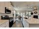 Bright, modern kitchen with white cabinets, stainless steel appliances, and an open layout to the dining area at 3985 Foxdale Ln, Cumming, GA 30028