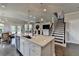 Modern kitchen with white cabinets, stainless steel appliances, quartz countertops, and an island with seating at 3985 Foxdale Ln, Cumming, GA 30028