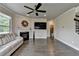 Comfortable living room featuring hardwood floors, a fireplace, a modern ceiling fan, neutral paint, and ample space at 3985 Foxdale Ln, Cumming, GA 30028