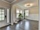 Inviting living room featuring wood floors, neutral walls, large windows, and great natural light at 3985 Foxdale Ln, Cumming, GA 30028