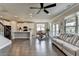 Open-concept living area with hardwood floors, modern kitchen, dining area, comfortable seating, and plenty of natural light at 3985 Foxdale Ln, Cumming, GA 30028