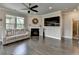 Living room boasts fireplace, neutral paint, ceiling fan, hardwood floors and built-in surround sound at 3985 Foxdale Ln, Cumming, GA 30028