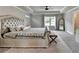 Main bedroom with a decorative bed, bench, patterned rug, and trey ceiling at 3985 Foxdale Ln, Cumming, GA 30028