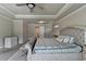 Spacious main bedroom featuring a decorative tray ceiling, a sitting area, and neutral tones at 3985 Foxdale Ln, Cumming, GA 30028