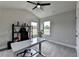 Bright office featuring gray walls, two windows, a ceiling fan, and an adjustable height desk at 3985 Foxdale Ln, Cumming, GA 30028