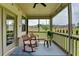 Relaxing screened porch with rocking chairs and outdoor views, ideal for enjoying tranquil moments at 3985 Foxdale Ln, Cumming, GA 30028