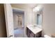 Bathroom vanity with a mirror above, doorway to the left, and toilet on the right at 532 Walton Dr, Woodstock, GA 30188